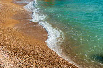 Wall Mural - Waves of the sea reaching the shore of the beach