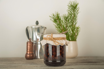 Natural organic jam from pine cones in a jar close-up. Organic jam for health and copy space.