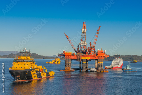 OLEN NORWAY - 2014 OCTOBER 16. The semi-submersible drilling rig West Alpha with Anchor Handling vessels during offshore operation.