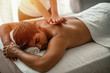 © Dragana Gordic - Close-up of masseur's hands and a client's back. A good-looking man getting a back massage lying down. Close-up of masseur's hands massaging a client's back.