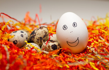 Easter colored eggs on the grass. Greeting Easter background. Funny and sweet smiles, the Concept of the Easter festival, religion.