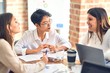 © Krakenimages.com - Beautiful businesswomen smiling happy. Sitting with smile on face working using laptop at the office