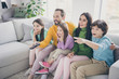 Dream harmony family spending time concept. Five people dad daddy mom mommy three kids boy girls sit divan watch tv schoolboy point index finger hold remote control in room living room