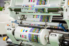 Large Offset Printing Press Or Magazine Running A Long Roll Off Paper In Production Line Of Industrial Printer Machine.