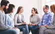 Psychotherapist talking with patients at support group meeting
