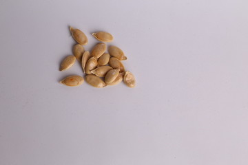 pumpkin seeds on color background