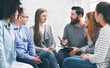 Therapist consulting patients of rehab group at therapy session