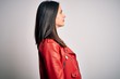 © Krakenimages.com - Young brunette woman with blue eyes wearing red casual jacket over white background looking to side, relax profile pose with natural face with confident smile.