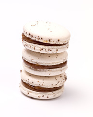 Wall Mural - Stack of French Caramel Macarons Three White Macarons on White Background Vertical Close Up