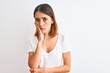 © Krakenimages.com - Beautiful redhead woman wearing casual white t-shirt over isolated background thinking looking tired and bored with depression problems with crossed arms.