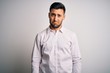 © Krakenimages.com - Young handsome man wearing elegant shirt standing over isolated white background depressed and worry for distress, crying angry and afraid. Sad expression.