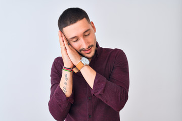 Wall Mural - Young handsome business man standing over isolated background sleeping tired dreaming and posing with hands together while smiling with closed eyes.