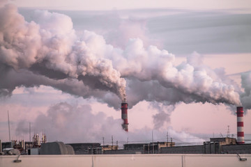 Wall Mural - industrial chimneys with heavy smoke causing air pollution as ecological problem on the pink sunset sky background