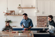 © Space_Cat - Positive family preparing meal together in the kitchen. Happy mom, dad and daughter cooking together at home