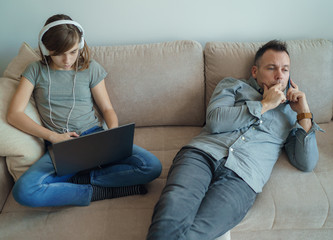 Technology addicted family: parents and child use laptop and mobile phones. Modern family values - Mom, dad with daughter obsessed with devices overuse social media, internet addiction concept.