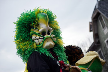 riedisheim - France - 8 February 2020 - People parading in the street with mask and green wig during the carnival