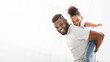 © Prostock-studio - Happy black father holding his little daughter on his back