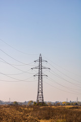 Wall Mural - High voltage post. High voltage tower on blue, clear sky.