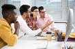 © chagin - Multy-ethnic group of young business people working with computer at office