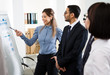 © chagin - Group of mixed business people having a meeting using a white board in an office