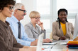 © chagin - Multy-ethnic group of business people working with computer at office