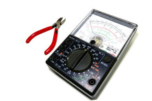 An Analog Black Multimeter With Pliers To Cut The Red Wires Placed On The White Background. Lumphun Thailand : 24 January 2019