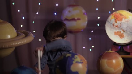 Wall Mural - Space Travel Game Inspiration Spaceship. Little Kid Boy Astronaut Launching Toy Rocket From Spaceport Through Planets. Child Dreamer Playing With Toy Space Rocket Flying Among Planets. SLOW MOTION.