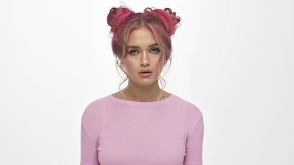 Poster - A displeased young woman with the colored pink hairstyle rolls her eyes isolated over white background