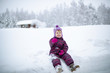 © Slava - A small girl is sitting on the snow