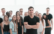 © ASDF - confident guy standing in front of a casual group of young people.