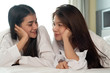 © Watcharin - Two beautiful women laying down on bed,looking eyes each other,feeling loved,romantic love couple,Lesbian concept,black and white tone