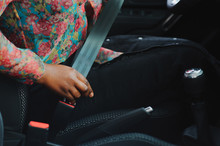 Dark Brown Skin African Woman Hand Buckling Safety Belt In The Car For Automobile Accident Safety Concept