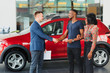 young african couple buying new car at dealership