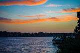 Fototapeta Tęcza - The sun sets over Lake Marble Falls, Texas.  