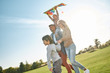© Svitlana - Let your children spread the wings. Happy family playing a kite. Outdoor family weekend