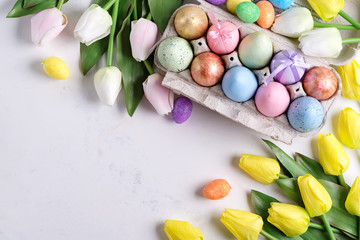 Wall Mural - Golden Easter Eggs in box with yellow tulips on stone marble background. Easter background or easter concept.