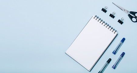 Wall Mural - Office supplies in blue background. Flat lay, top view