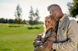 © Svitlana - Happy together. Portrait of a couple in love hugging and smiling while standing in the middle of the beautiful park