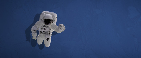 Wall Mural - isolated simple astronaut uniform, scafandr and mask against the color wall background, wide banner.