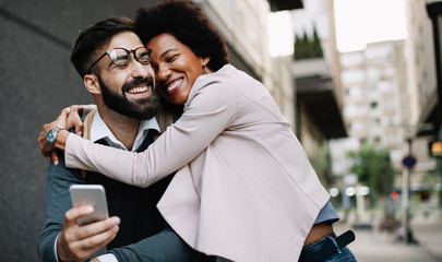 Happy loving couple. Happy young man and woman having fun together in city