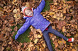© Cavan Images - Little girl playing in the leaves in a park in Vienna, Austria.