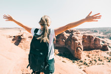 Wide-angle Shot Of A Young Woman Spreading Arms Over A Canyon Lookout