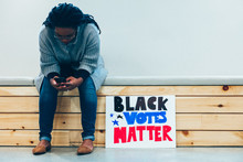 Person Sitting With Their Black Votes Mstter Sign