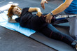© Cavan Images - Personal trainer assisting woman with disabilities in her workout