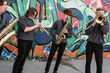 © Hill Street Studios - High school jazz band brass musicians by graffiti mural