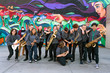 © Hill Street Studios - High school jazz band musicians in front of urban graffiti mural