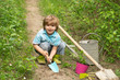© Volodymyr - Children summer activities. Carefree childhood. Little Farmer boy examining Common fig crop in plantation or field.