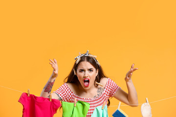 Poster - Angry housewife with laundry on color background