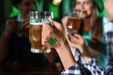Young Woman With Friends Celebrating St. Patrick's Day In Pub