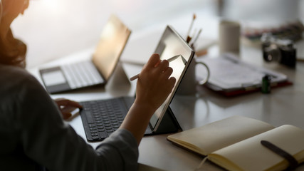 Close up view of female professional designer drawing on digital tablet